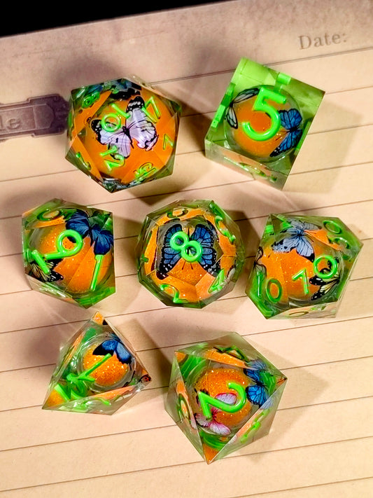 7 Piece Sharp Edge Resin Dice, Orange Sand Butterfly, Transparent with Green Numbers